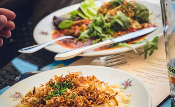 person holding stainless steel fork and knife